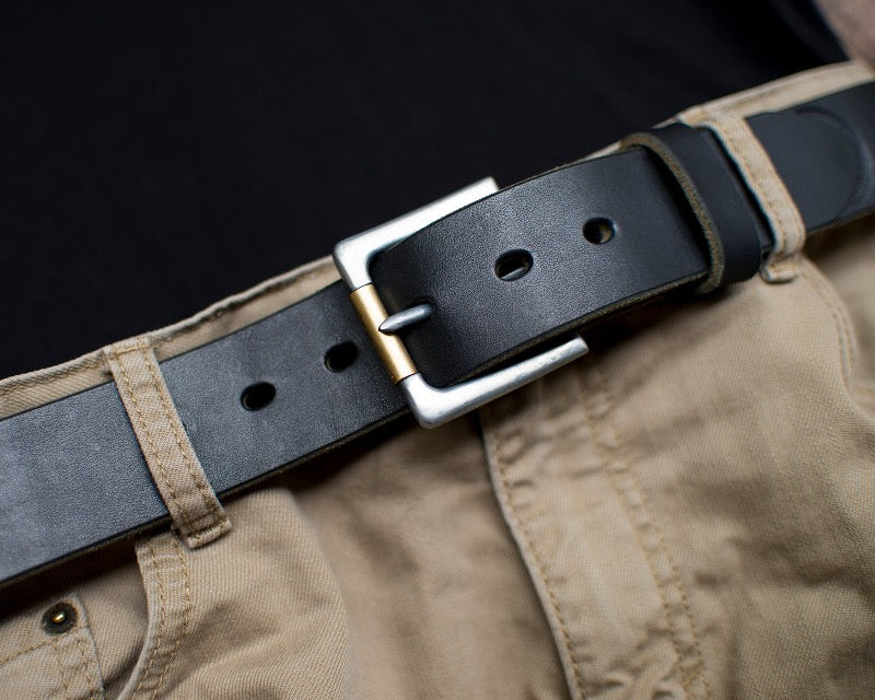 Handmade black full grain leather belt with exquisite craftsmanship and natural texture shown being worn