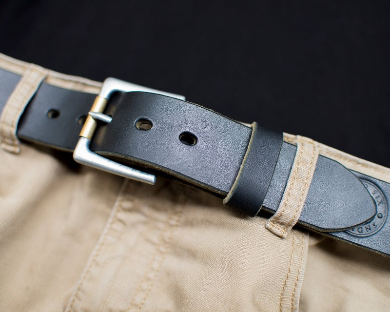 Handmade black full grain leather belt with exquisite craftsmanship and natural texture shown being worn