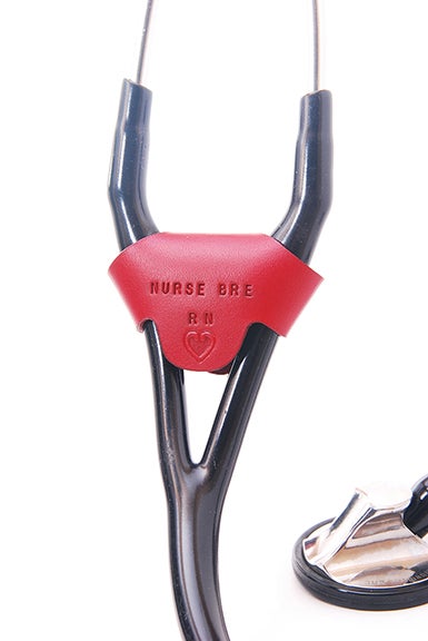 Red leather stethoscope identification tag wrapped around a black cardiology stethoscope