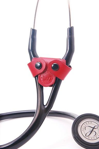 Red leather stethoscope identification tag wrapped around a black cardiology stethoscope