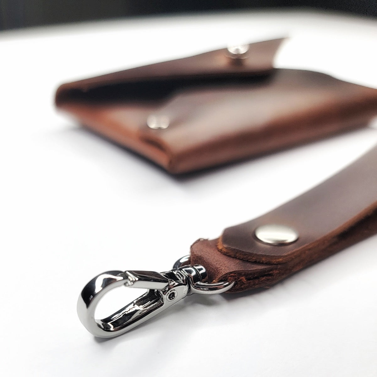 Handmade brown leather wristlet wallet with chrome Sam Browne button with cash compartment by Echo Six Designs