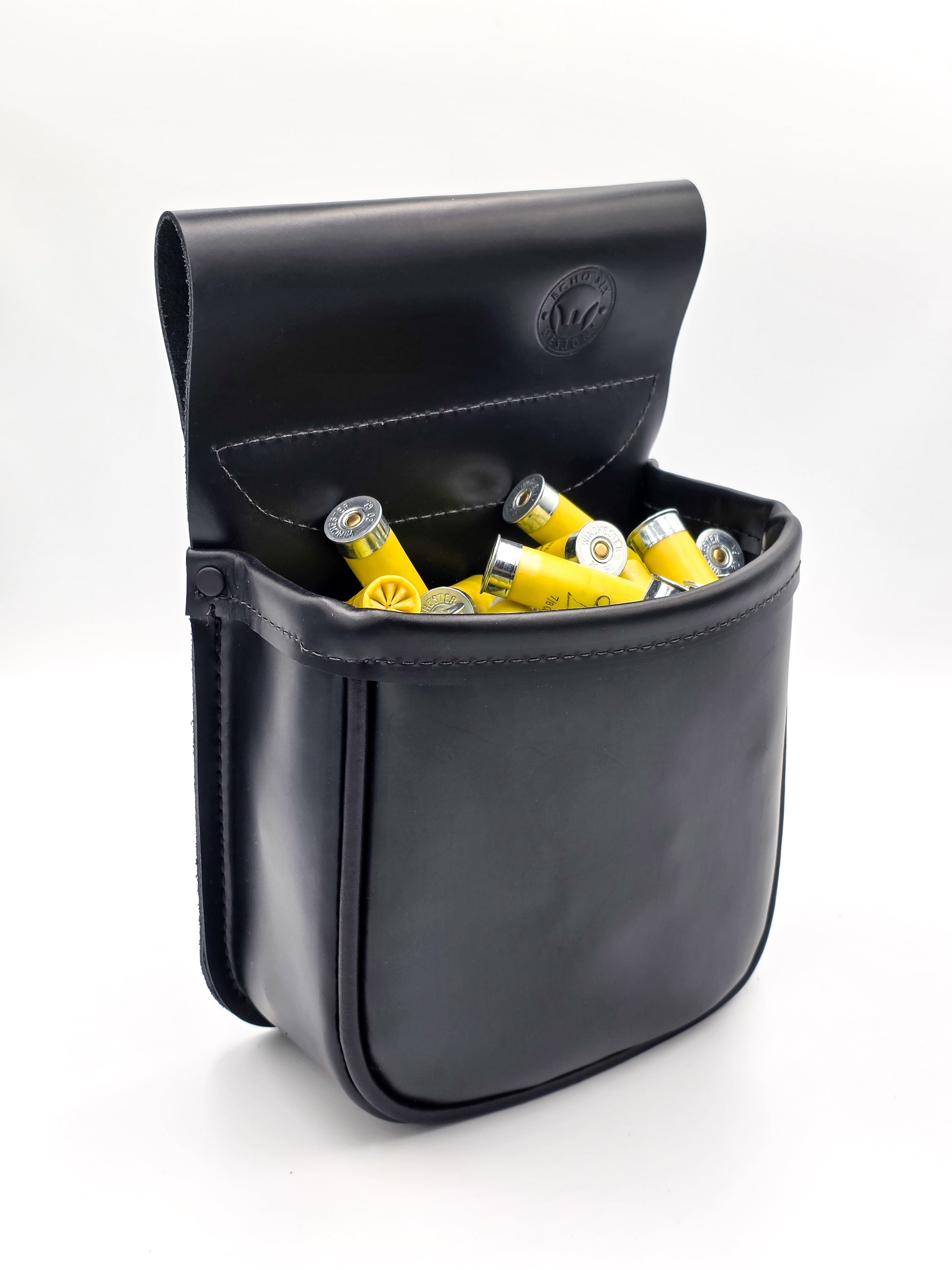 Black leather case with yellow and silver shotgun shells on a white background